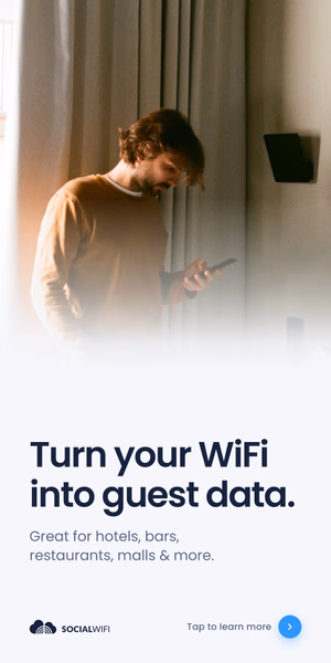 Man checking his phone next to a WiFi access point mounted on the wall, with the headline 'Turn your WiFi into guest data'