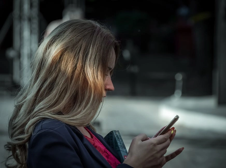 woman talking to a phone held in front of her