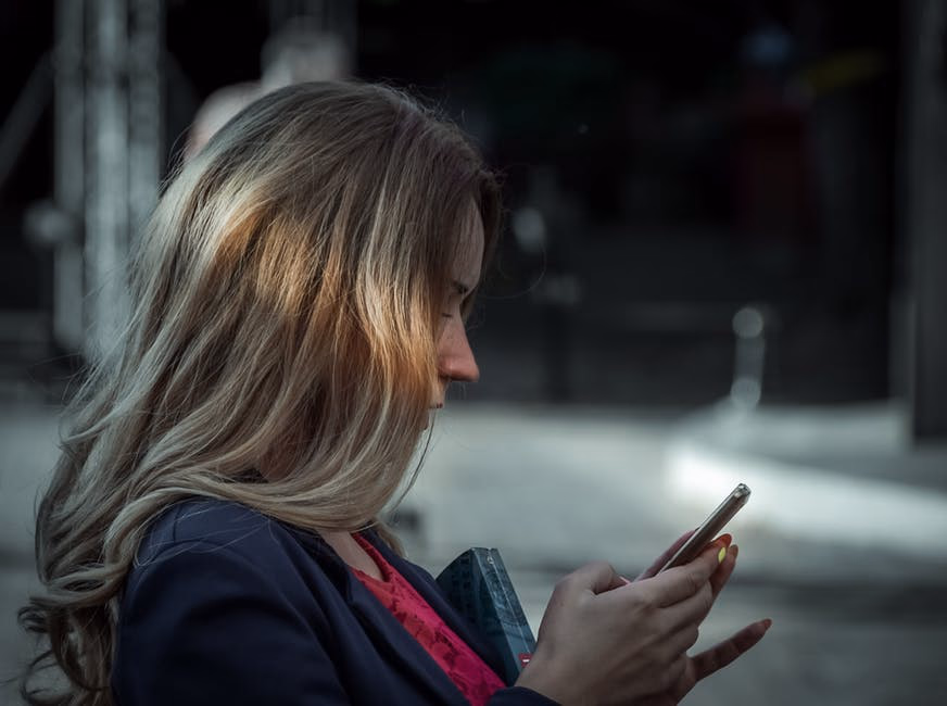 woman talking to a phone held in front of her