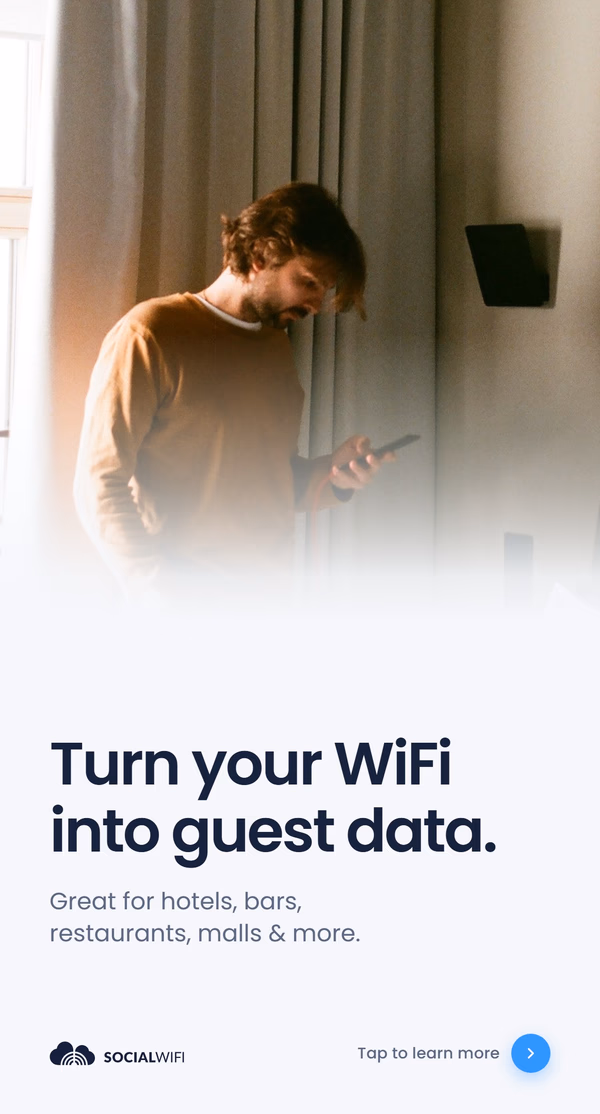 Man checking his phone next to a WiFi access point mounted on the wall, with the headline 'Turn your WiFi into guest data'