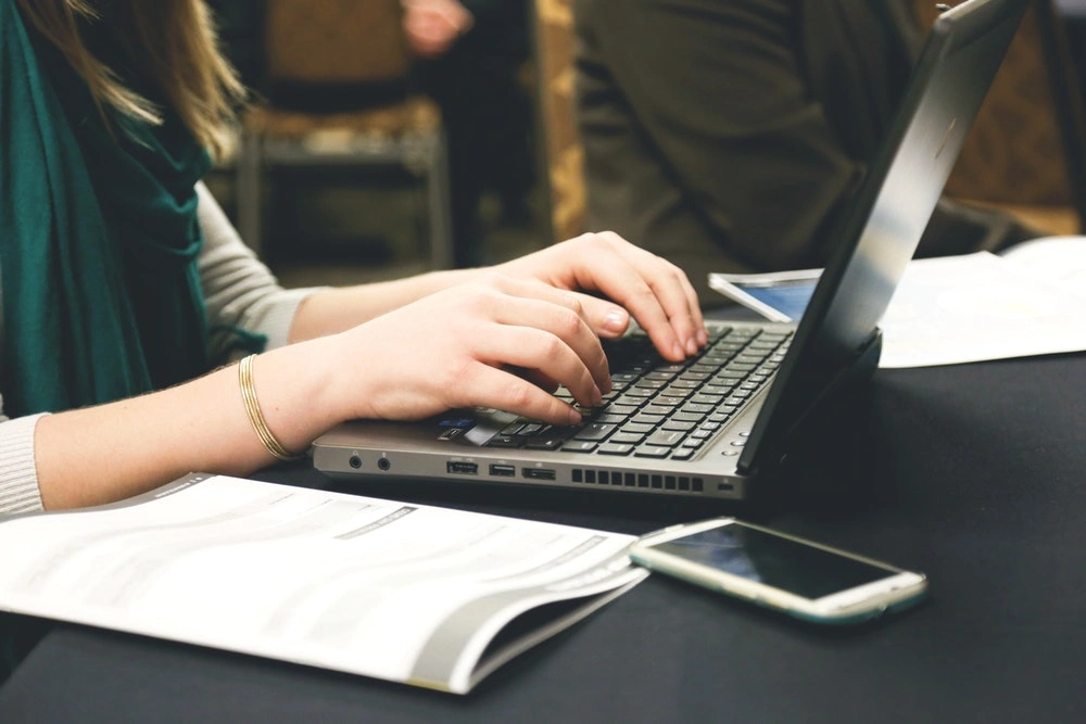 woman typing on a laptop