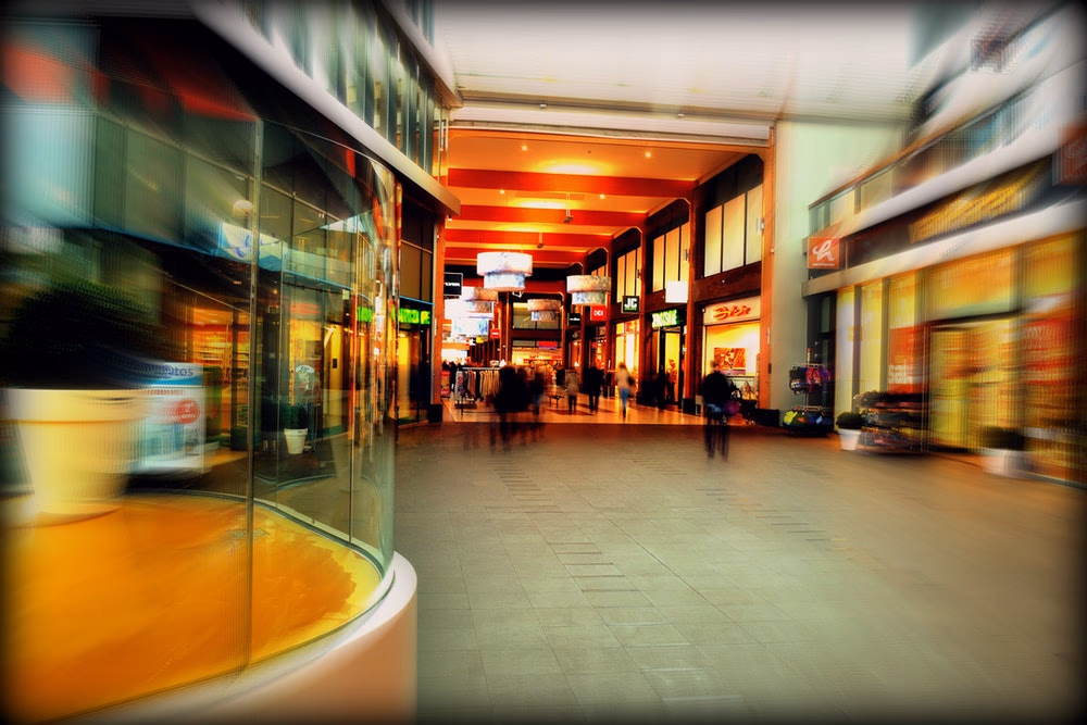 blurred out shot of a busy shopping mall corridor