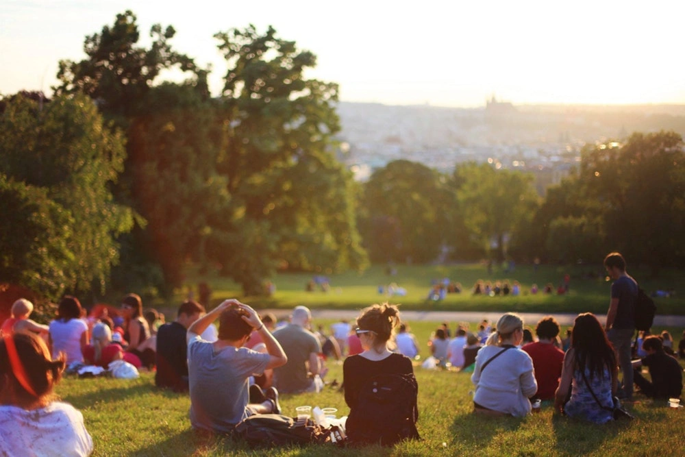 young people sitting in a park