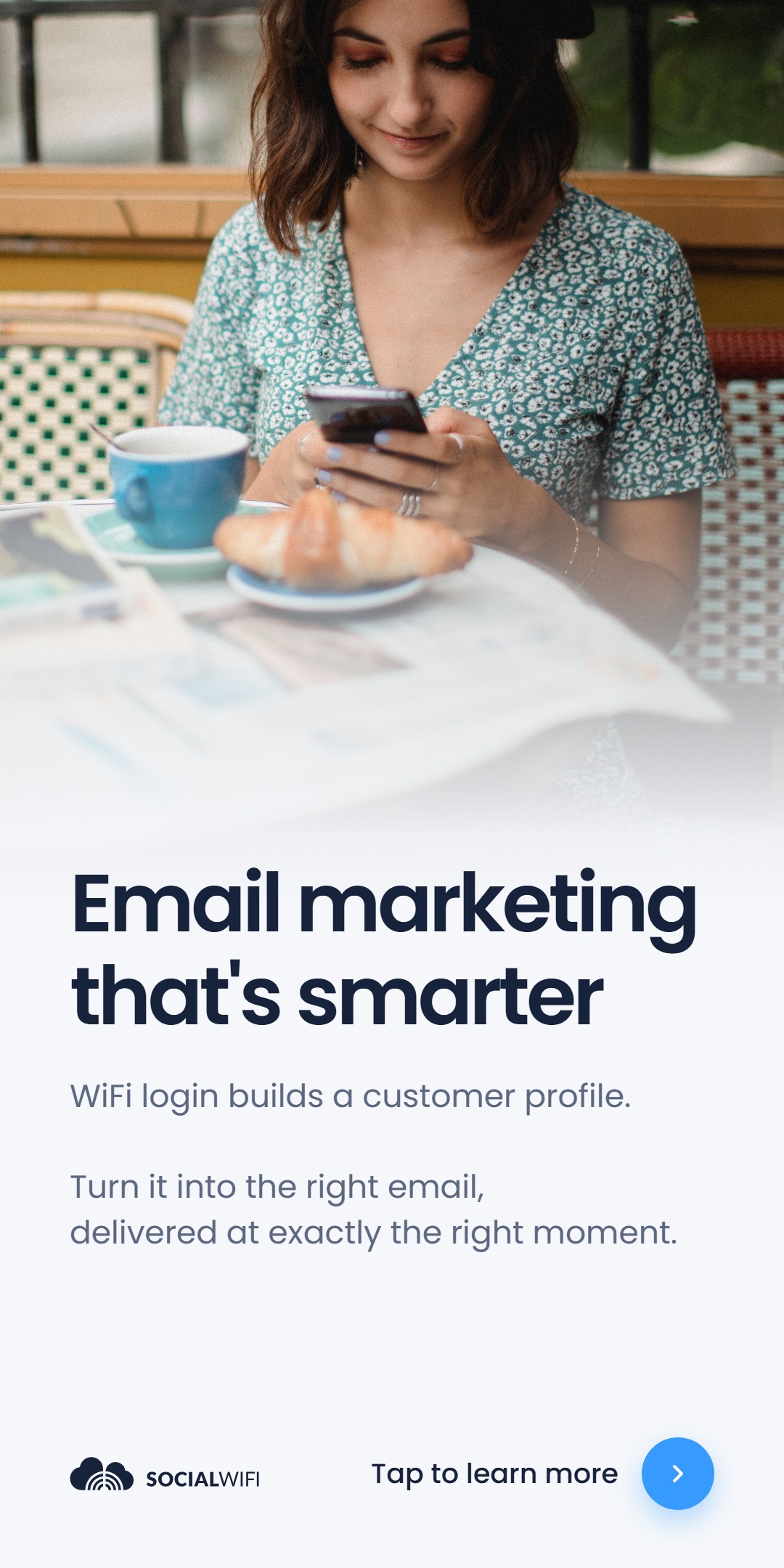 Guest relaxing at a cafe table with coffee and a croissant while checking her phone, next to the headline 'Email marketing that's smarter'